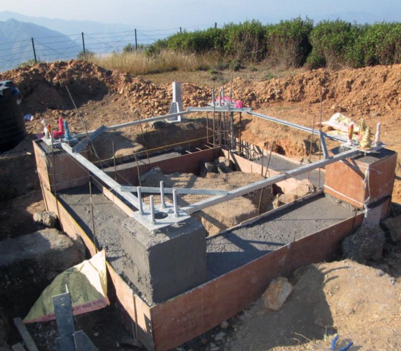 BTS tower foundation under construction on a hillside site