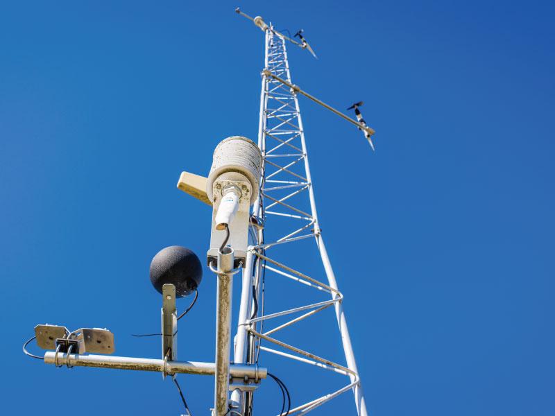 Weather and telemetry sensors mounted on a lattice mast