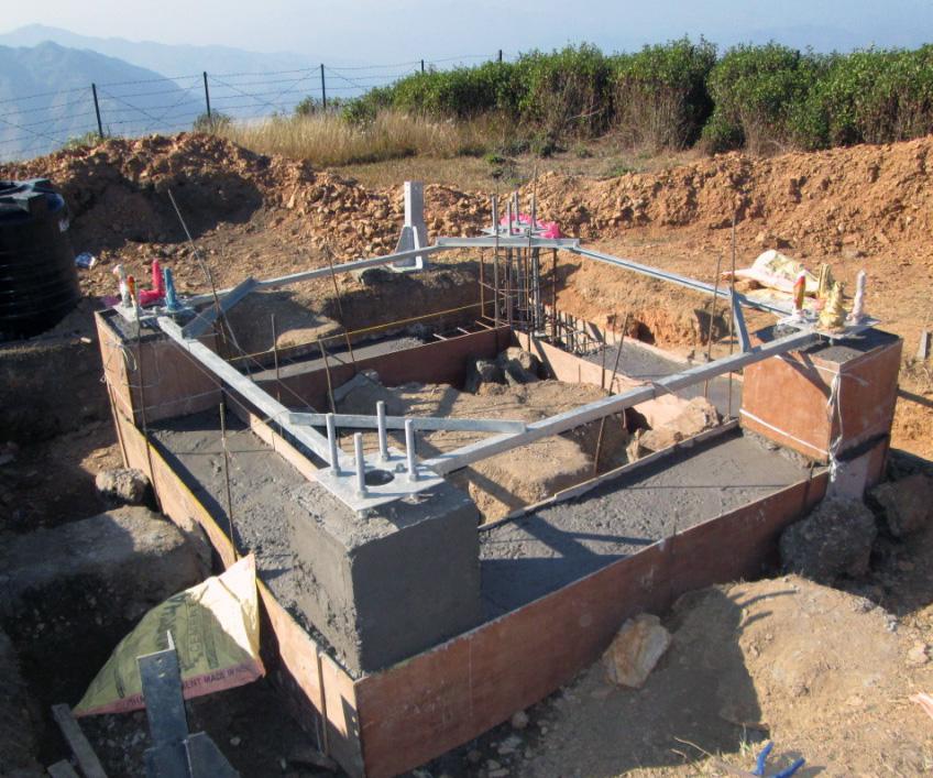 BTS tower foundation under construction on a hillside site